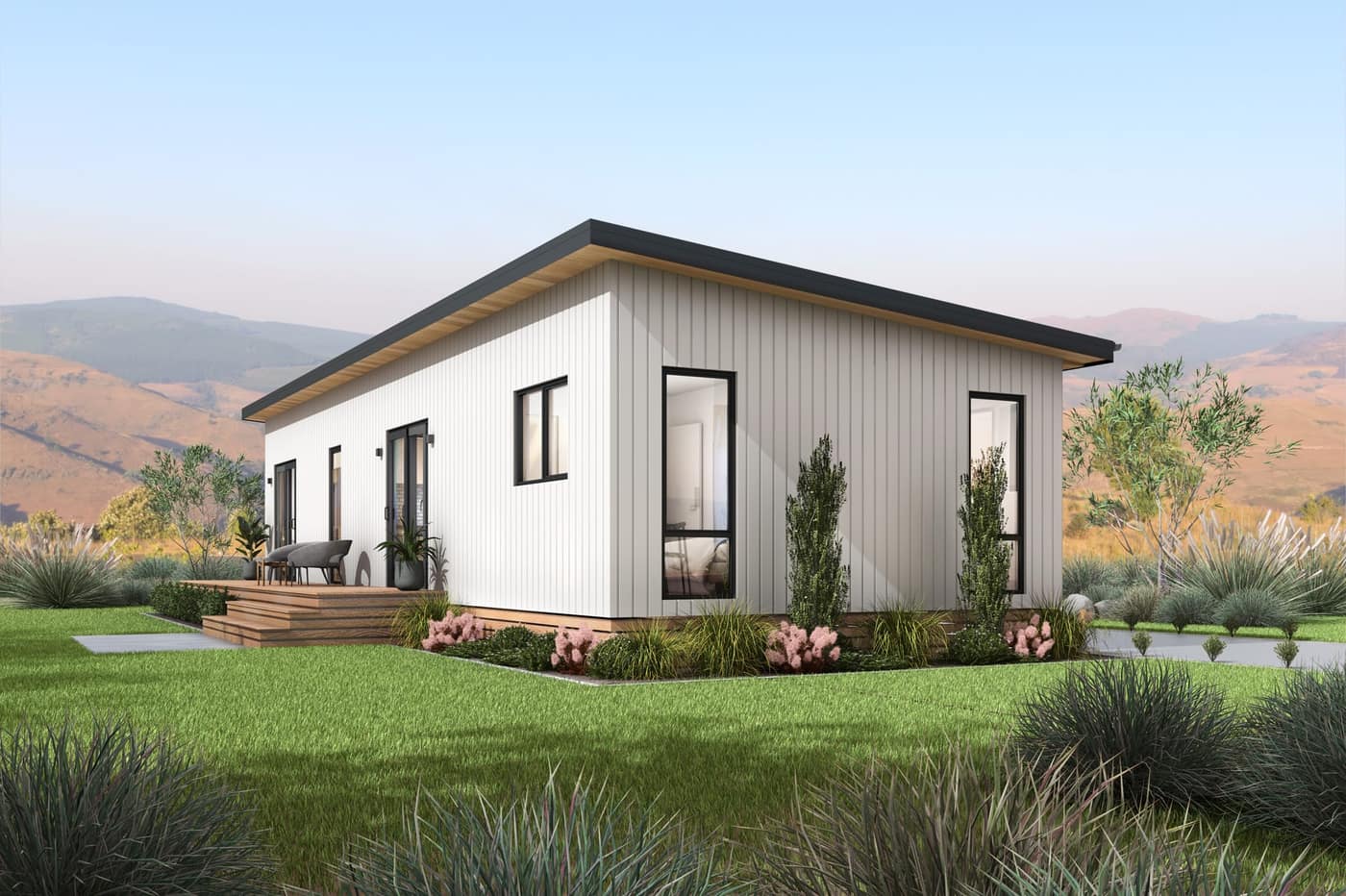 Exterior of a Paragon Portables three-bedroom transportable home with vertical white cladding and a landscaped garden